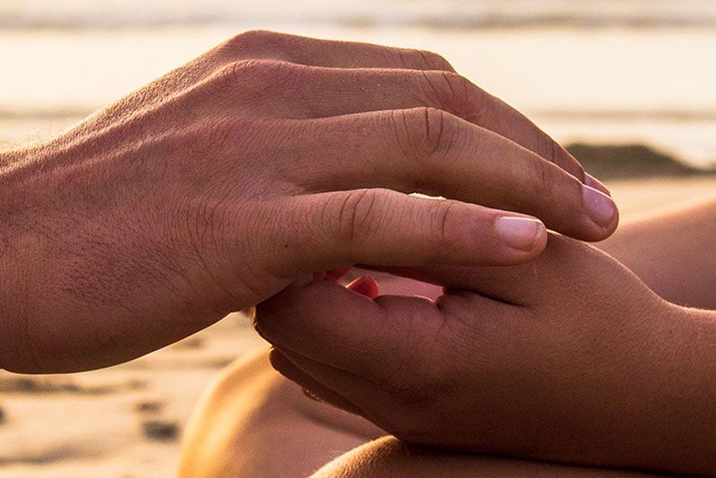 Two people touching hands.